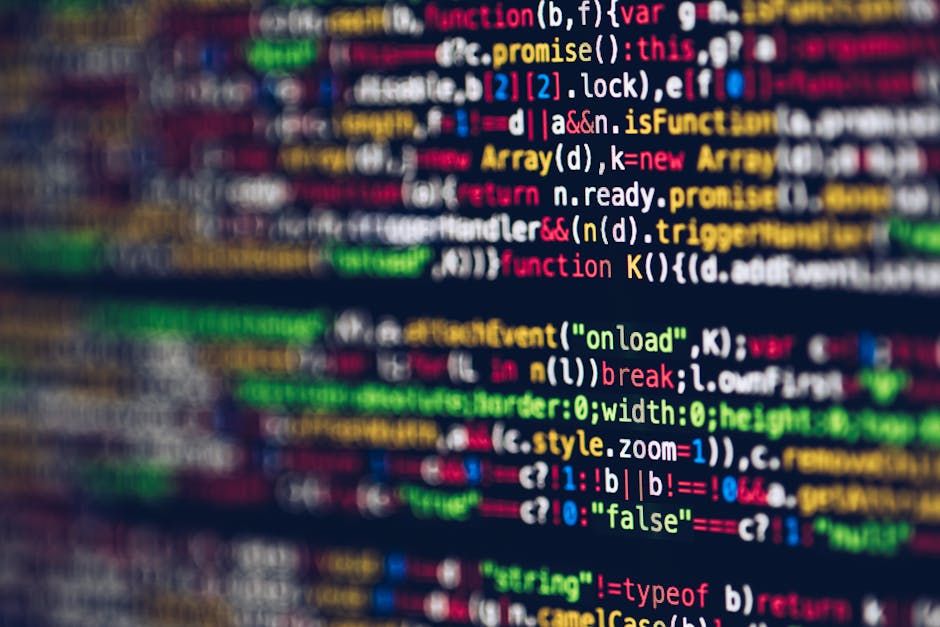A close-up view of a computer screen displaying lines of colorful programming code in various hues such as red, green, blue, yellow, and white on a dark background. The code features syntax highlighti